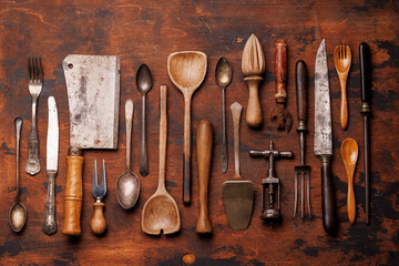 A collection of various retro kitchen and cooking utensils displayed on a table