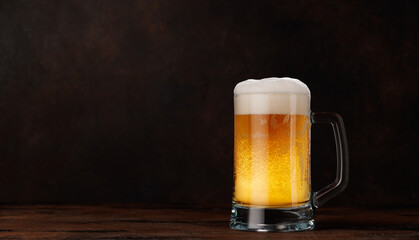 A glass of beer with a golden hue and frothy head