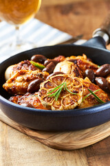 Grilled chicken pieces with kalamata olives and fresh rosemary. Close up.