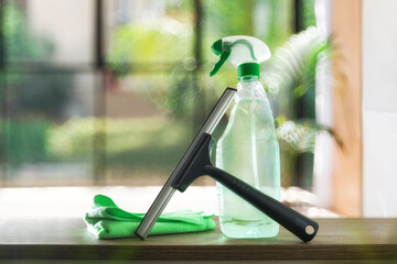 Window cleaner tools on wood table and background window