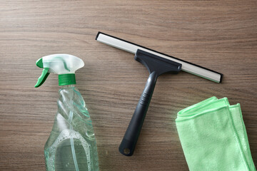 Window cleaner tools on wooden table