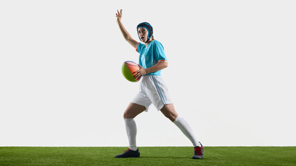 Energetic female rugby athlete poses in sports attire on a white background. Concept of passing action, team coordination, fast movement and high-energy sports scene