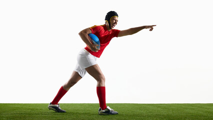 Rugby athlete advancing on grass pitch with outstretched arm. Concept of command gesture, team leadership, match situation and communication in game