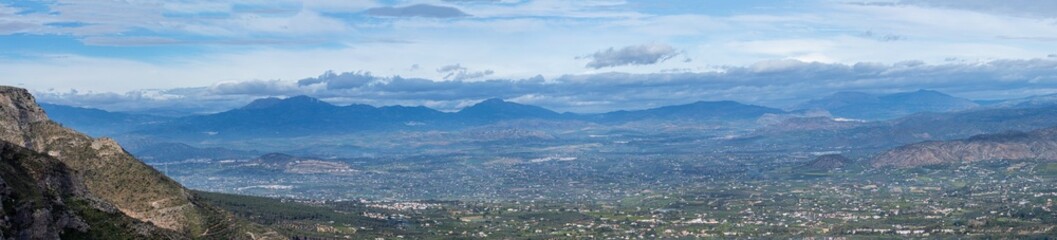 Hiking on trail along abandoned open-pit mine and burnt trees near Mijas, Spain 