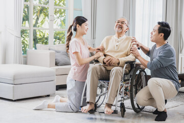 happy Asian family, senior man on wheelchair with daughter and son at home