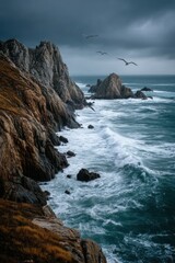 Obraz premium Dramatic coastal cliffs with crashing waves under a stormy sky