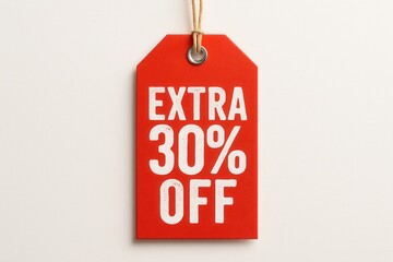 A red promotional tag with the text "Extra 30% Off" in bold white letters, attached with a string, symbolizing a sales discount or special offer.