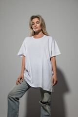 Confident Woman Wearing Oversized White T-Shirt with Blank Space for Mockup