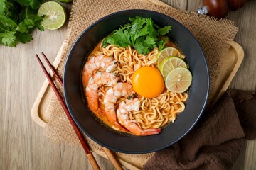 Tom yum kung with noodles , thai style instant spicy noodles with shrimp and egg , noodles tom yum with shrimp and egg	
