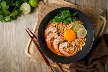 Tom yum kung with noodles  , thai style instant spicy noodles with shrimp and egg , noodles tom yum with shrimp and egg 