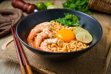 Tom yum kung with noodles  , thai style instant spicy noodles with shrimp and egg , noodles tom yum with shrimp and egg 