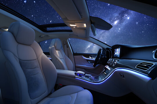 futuristic car interior with ambient lighting touch controls and panoramic sunroof showing night sky