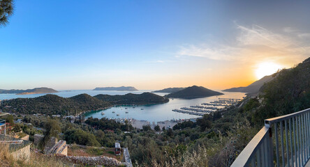 Stunning View of Kas Harbor at Sunset, Turkey. Calm Mediterranean Sea, Sailing Yachts, Green Hills, Remote Islands and Golden Light Over Peaceful Coastal Landscape