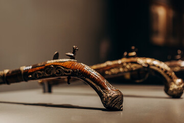 Vintage Ornate Flintlock Pistols Displayed in a Museum Setting