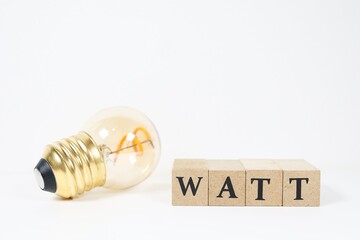 電球とWATTの文字で電力消費を表現したイメージ