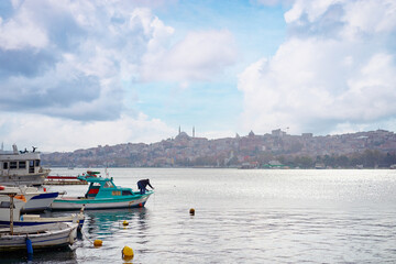 Peaceful View of Boats Along Istanbul Waterfront on a Cloudy Day