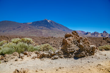 Mount Teide, a striking volcanic peak in Tenerife, stands majestically within a rugged landscape