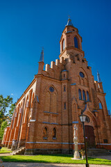 Neo-gothic brick Church of the Holy Virgin Mary Scapulary in Kernave, Lithuania, featuring a tall...