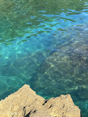 Turquoise clear clean sea and rocks.