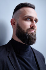Studio portrait of young handsome man with beard.