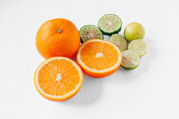 Citrus fruit of Halved orange fruit, slices lemon or lime fruit and bergamot fruit on white background,
