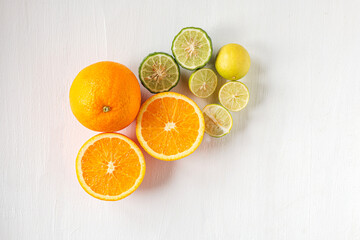 Citrus fruit of Halved orange fruit, slices lemon or lime fruit and bergamot fruit on white background, Top view