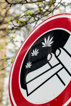 Vertical detail of red, blue and white street sign showing the public area where cannabis smoking is tolerated in Amsterdam. Marijuana smoking in the Netherlands