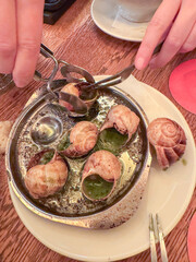 French Escargot with Garlic Herb Butter Served in Metal Dish with Special Tongs and Forks
