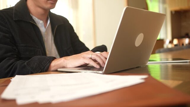  programmer man hand typing configuration on keyboard at laptop for input coding language to software for fix bug and defect of system in data center room , engineering and technology