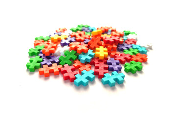 Stack of colorful jigsaw puzzle on white background