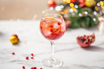 Pomegranate Champagne Spritz. Festive alcohol drink with pomegranate and lime slice  for eve christmas