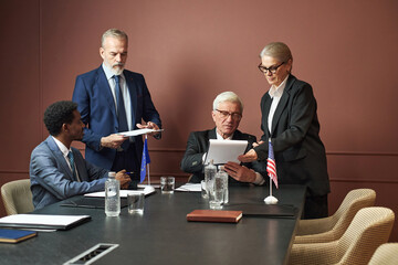 Group of middle aged and senior politicians including Caucasian man, Black man, Caucasian woman...