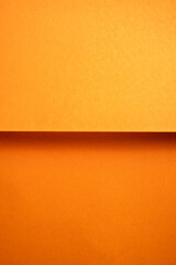 Fototapeta premium Orange folded paper texture abstract background. Folded paper surface. Copy space
