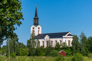 Naklejka premium Bergby, Sweden A vie wof the Hamrånge kyrka or Hamrånge church in summer in the Gästrikland region.