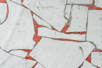 Background with a decorative mosaic made of red and white broken ceramic tiles, assembled from tile waste.