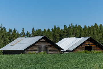Nastelns, Sweden Two small wooden barns in a field.