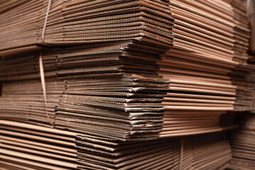 Stack of cardboard sheets in warehouse storage environment. Large stack of cardboard sheets...