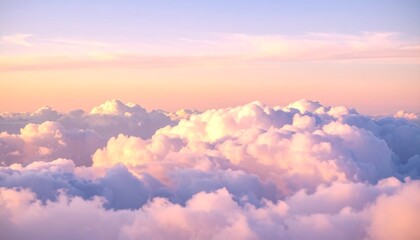Serene aerial view of a sea of clouds bathed in the warm, gentle light of a pastel-colored sunset or sunrise.