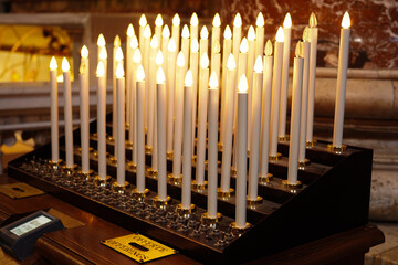 Church candles lit with offerings	