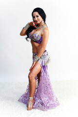 Elegant Brunette Dancer in Traditional Eastern Dance Costume Showcasing Beauty.