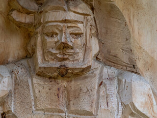 Close-up wooden carving of human figure