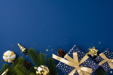 Christmas-themed arrangement featuring presents, ornaments, and greens on a bold blue surface