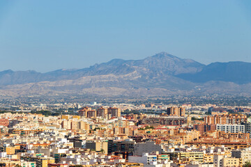 Aerial view of Alicante, Spain showcasing a vibrant cityscape with a backdrop of the Sierra de...