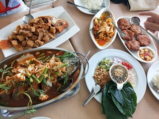Traditional Thai food set with various authentic dishes on table