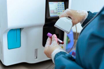 Lab Technician Scanning Blood Sample with Barcode Reader for Clinical Analysis