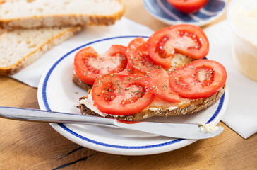 two bruschettas with tomato slices on a plate