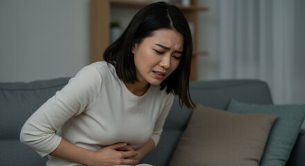 Young woman experiencing abdominal pain health and well being