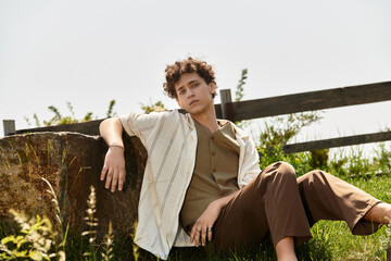 Stylish young man enjoying a sunny day in a lush green park