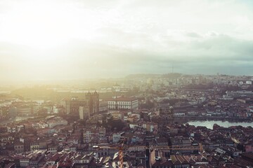 Views across Vila Nova de Gaia and Porto reveal rooftops bathed in gentle sunlight, hinting at a lively city awakening. Sights include Douro River, promising unique travel experiences