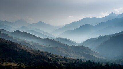 Fototapeta premium Misty mountain landscape with layered ridges fading into the distance